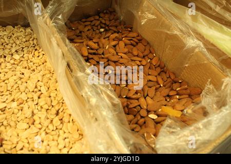 nuts, almonds and peanuts in boxes and bags in the store. Purchase and quality of food nuts in the store. Stock Photo