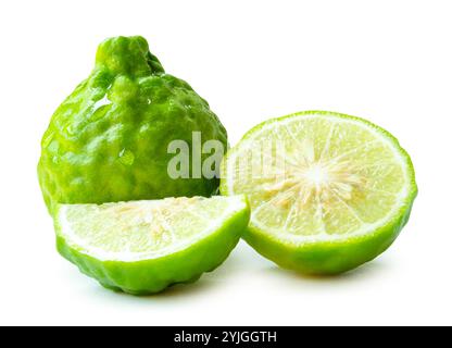 Front view of fresh green bergamot fruits or kaffir lime with half and quarter or slices but no green leaf in stack is isolated on white background Stock Photo