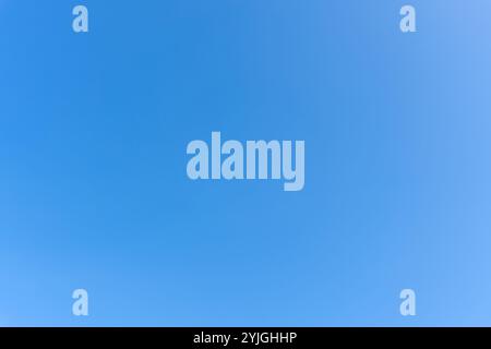 Low angle view and full frame of beautiful blue sky without clouds in the morning or evening is used as natural background texture Stock Photo