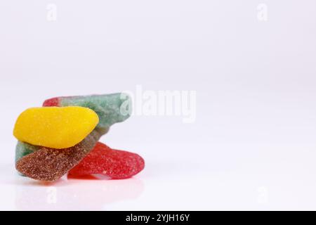 A mountain of gummy candies in assorted flavors and colors on a white background, offering a delicious, colorful array of sweet treats Stock Photo