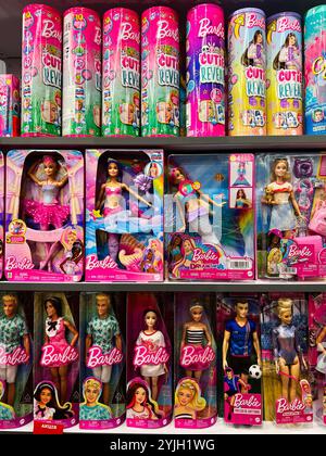 Kyiv, Ukraine - November 14, 2024: Colorful assortment of Barbie dolls and accessories are neatly arranged on retail shelves, showcasing different the Stock Photo