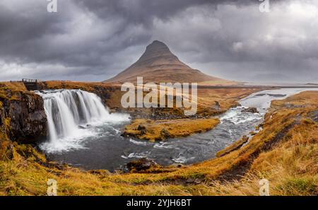 Panorama of the Kirkjufell mountain and Kirkjufellfoss waterfall, Snaefellsnes peninsula, Iceland. Long exposure shot in autumn. Stock Photo