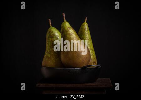 Close-up of green pears on a black plate Stock Photo