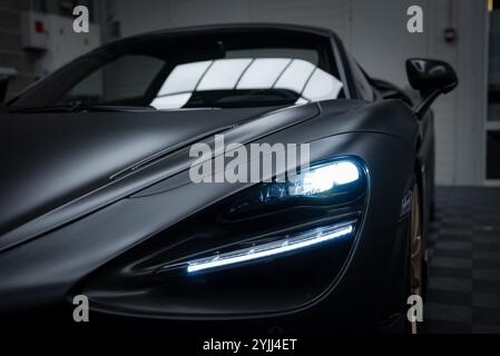 Close Up of McLaren 720S with Matte Black Finish in Indoor Setting Stock Photo