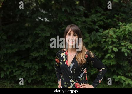Fashion portrait of healthy, happy young woman with leafy backdrop Stock Photo