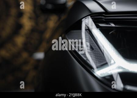 Close Up of Illuminated Lamborghini Urus Performante Headlight Stock Photo