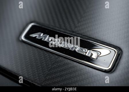 Close Up of McLaren Emblem on Carbon Fiber Background Stock Photo