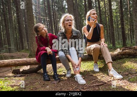 Senior woman dislocates ankle on forest strolling Stock Photo