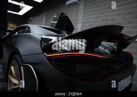 Close Up of McLaren 720S with Carbon Fiber Spoiler in Showroom Stock Photo