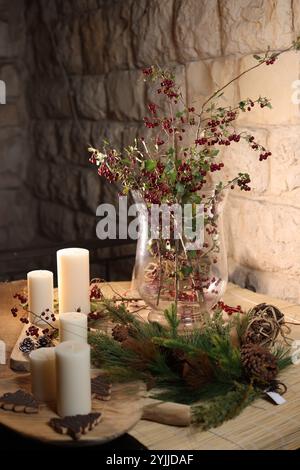 Autumn-themed Christmas decorations with candles, warm tones, fall foliage, and rustic, cozy holiday charm. Stock Photo