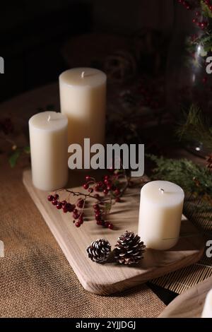 Autumn-themed Christmas decorations with candles, warm tones, fall foliage, and rustic, cozy holiday charm. Stock Photo