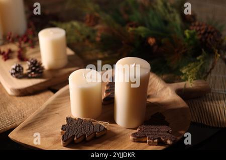Autumn-themed Christmas decorations with candles, warm tones, fall foliage, and rustic, cozy holiday charm. Stock Photo
