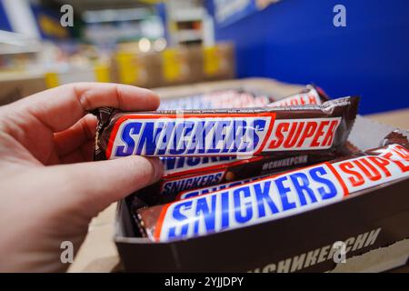 Tyumen, Russia-November 02, 2024: Snickers chocolate bar. Snickers bars are produced by Mars Incorporated. Stock Photo