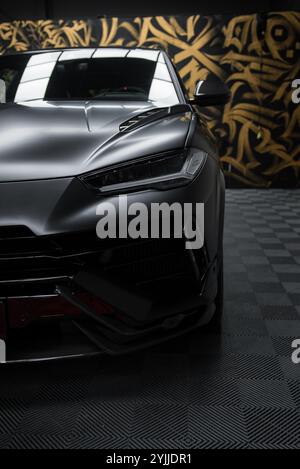 Close Up of Lamborghini Urus Performante with Abstract Mural Stock Photo