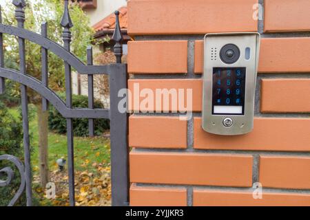 Gate intercom keypad on brick pillar Stock Photo