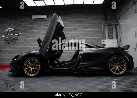 McLaren 720S with Dihedral Doors Open in Industrial Setting Stock Photo