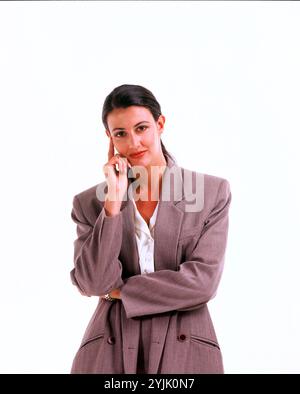 Lifestyle / business. Studio image of young woman wearing a suit. Stock Photo