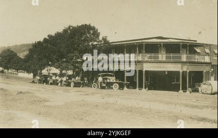 Motorists stopping at Fitzpatrick's Hotel in Kuranda, View of the main street in Kuranda with early motor cars and trucks, 1930s.  Photo Credit Graham Jenkinson,   source State Library of Queensland Stock Photo