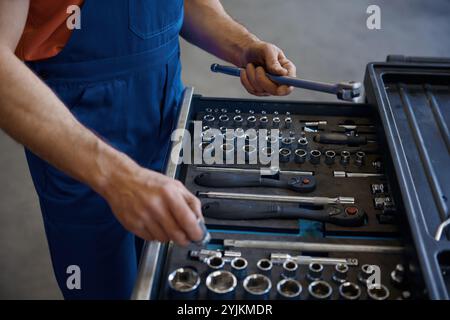 Closeup high angle view on tool box and male mechanic hands taking wrench Stock Photo
