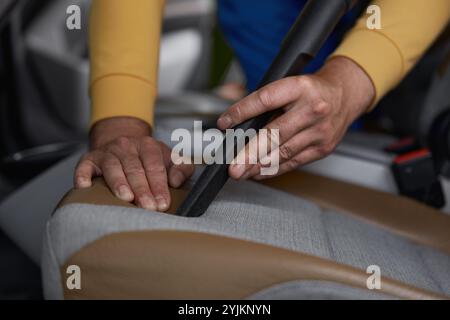 Closeup of vacuuming car interior from dust using professional equipment Stock Photo