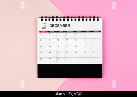 December 2024 desk calendar on pink color background.. Page of annual monthly calendar for your plan. Stock Photo