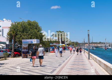 Lagos Portugal tourists and visitors walking on the promenade Stock Photo