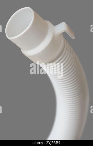 close-up of flexible drain hose or pipe of washing machine isolated gray background, end of plastic or pvc flexi pipe used in plumbing system Stock Photo