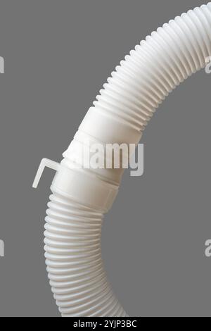 close-up of flexible drain hose or pipe connection isolated gray background, end of plastic or pvc flexi pipe used in plumbing system for water supply Stock Photo