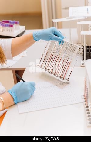 Laboratory technician analyzing blood samples for diagnostics in a clinical laboratory Stock Photo