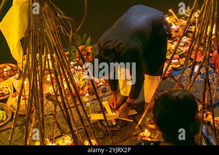 Kathmandu, Nepal - November 07, 2024 : Chhath Puja Parwa Sun God Celebration with Fruits, Lights and Lamps in river side pond in Nepal and India with Stock Photo