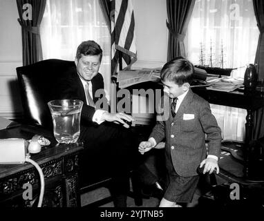 President John F. Kennedy visits with his nephew, Robert F. Kennedy, Jr.; RFK, Jr., presented his uncle with a salamander, 'Shadrach.' in the Oval Office, White House, Washington, D.C. 1961 Stock Photo