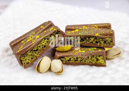 Dubai Chocolate bar with green kadayif and pistachio spread with pistachio nuts close up Stock Photo
