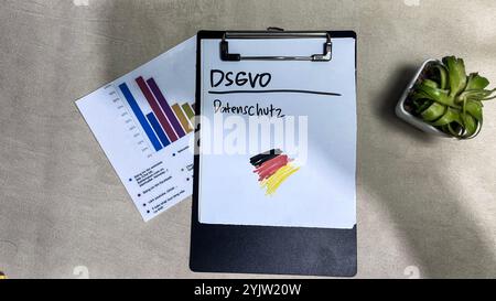 Concept of DSGVO - Datenschutz Grundverordnung ordner im buro on German Language write on paperwork on Wooden Table. German Language it means General Stock Photo