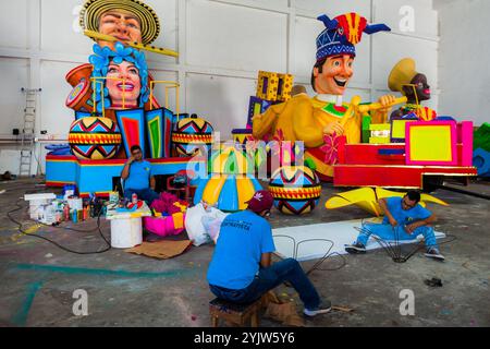 Colombian artisans work on wireframes for an allegorical float at the Carnival float workshop in Barranquilla, Colombia. Stock Photo