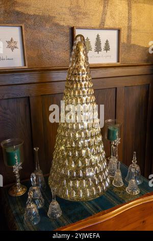 Full frame texture background of a small side table decorated with an assortment of various vintage Christmas tree figurines and ornaments Stock Photo