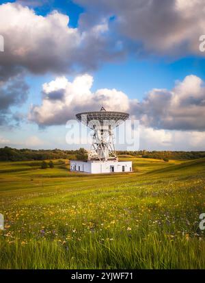 A large Satellite dish or antenna pointing directly upwards and sending and receiving signals and messages from deep space Stock Photo