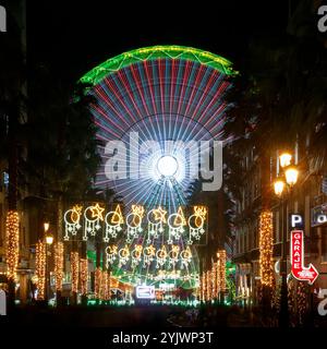 Vigo, Spain - December 10, 2023: Christmas ferris wheel in Vigo, Galicia, Spain, photographed at slow speed and in the foreground Christmas lights on Stock Photo