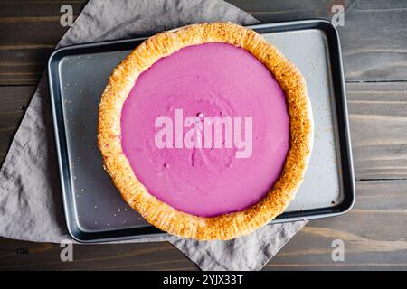 Blind Baked Pie Crust with Purple Sweet Potato Pie Filling: Unbaked purple sweet potato pie with pecan shortbread cookie crust and turbinado sugar Stock Photo