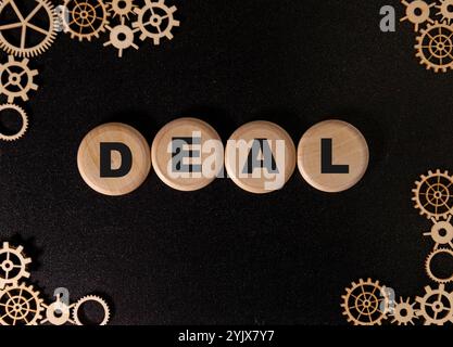 Word of A Great Deal. Text written by wood toy or wood cubes on white paper background with texture. Top view of wooden english alphabet arranging to Stock Photo