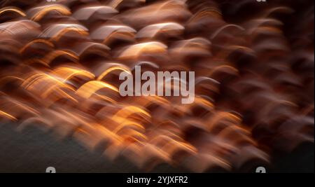 abstract blur of gold purple and orange light special effect created by long time exposure and intentional camera movement horizontal wavy backdrop Stock Photo