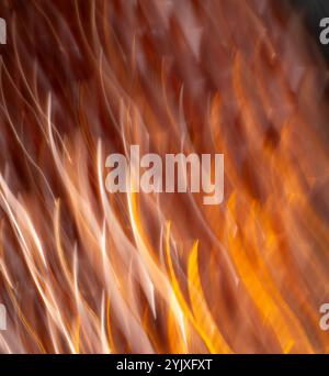 abstract blur of gold purple and orange light special effect created by long time exposure and intentional camera movement vertical golden bright Stock Photo