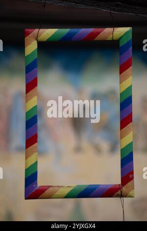 multi coloured striped rectangular painted wooden frame with yellow red blue purple and green primary colors in stripes empty framed blank space Stock Photo