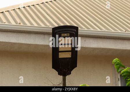 LED, solar-powered, motion detection security street light panels used to secure private residential homes and public spaces in modern day africa Stock Photo