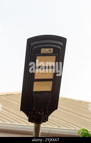 LED, solar-powered, motion detection security street light panels used to secure private residential homes and public spaces in modern day africa Stock Photo