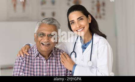 Portrait of happy older man and nurse posing for camera Stock Photo