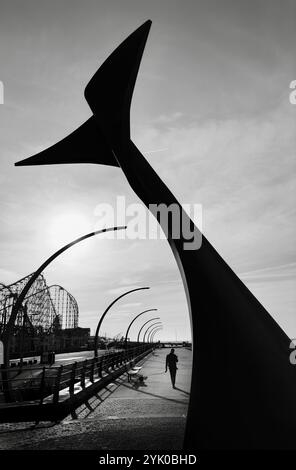 Whale Tail sculpture (wind shelter) on Blackpool South promenade with curved modern lights and backlit by sun. Blackpool UK Stock Photo