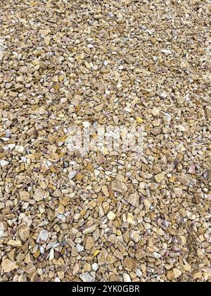 Gravel crashed and compact beige color background, texture. Natural rock floor layer Stock Photo