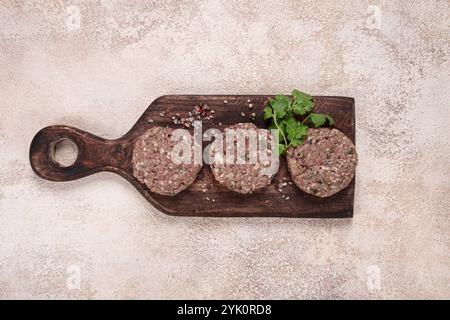 Raw cutlets, minced meat, on a chopping board, homemade, top view, no people Stock Photo