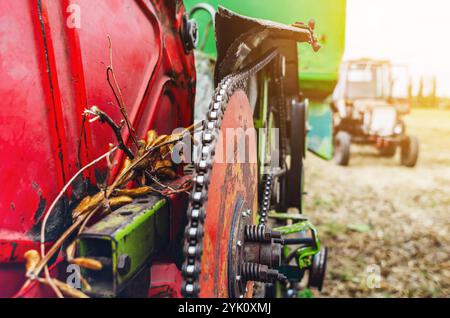 Part of red combine harvester. Chains, gears, transmission mechanisms. Agricultural industry. Blurred Stock Photo