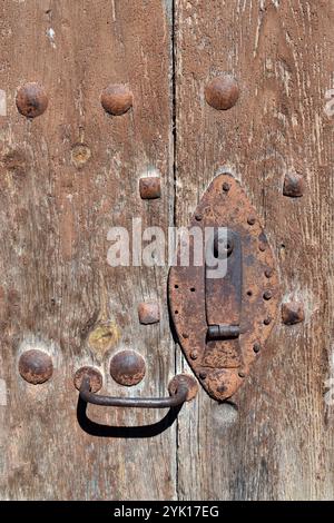 Rusty iron lock on an old wooden door Stock Photo